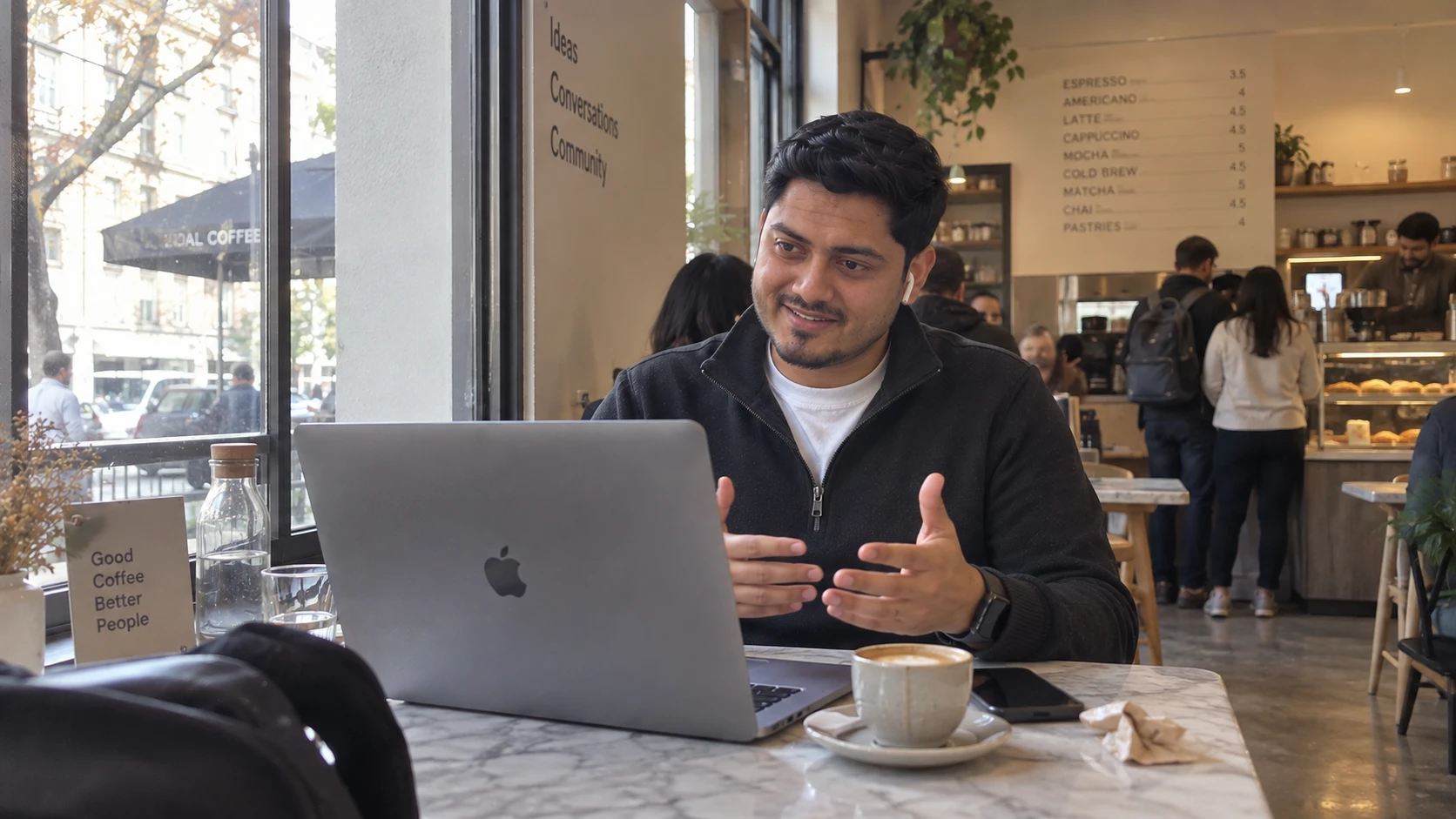 Ar.Bhavesh Panse on a client call from a coffee shop, laptop open