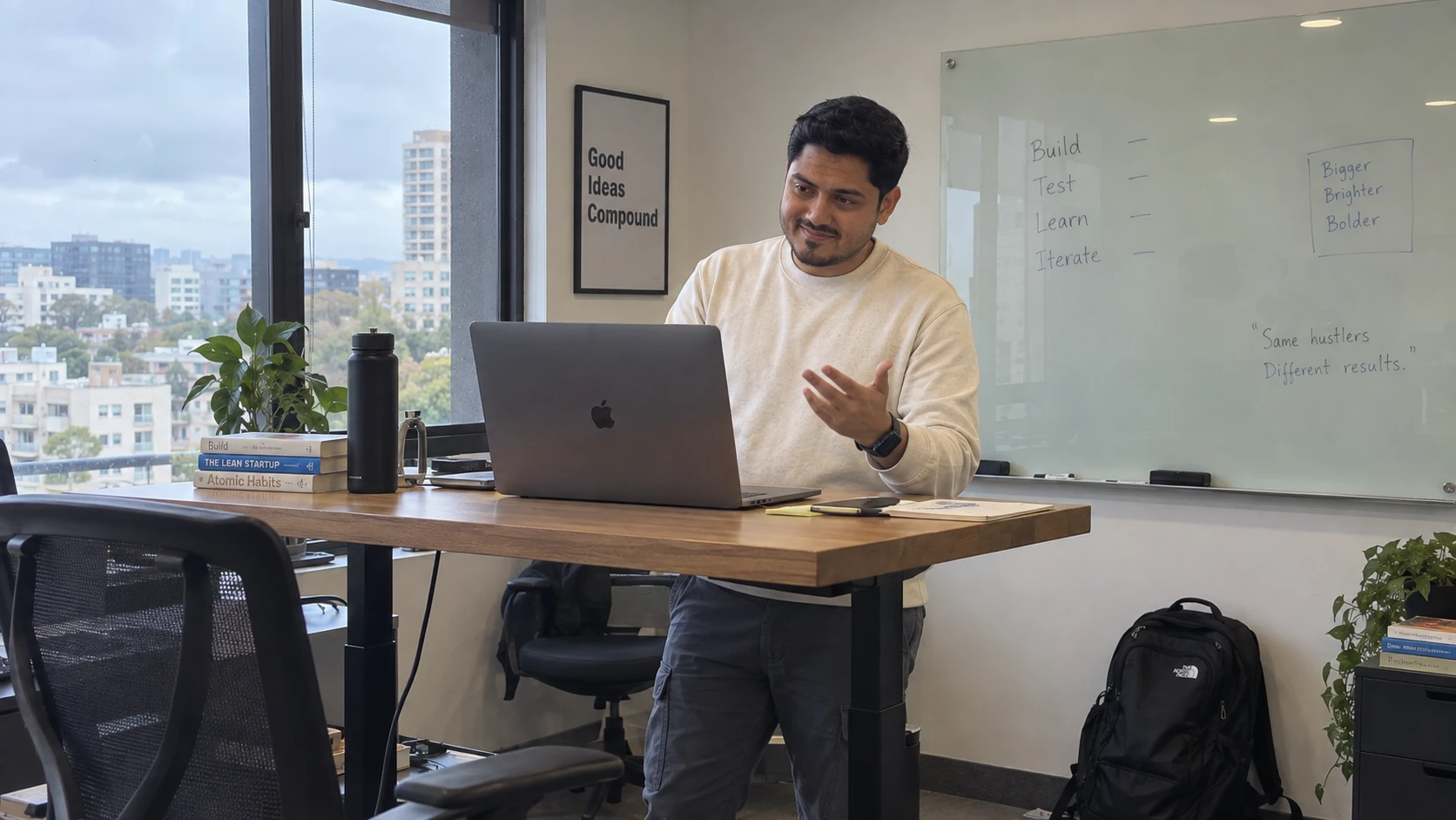 Ar.Bhavesh Panse at a standing desk, build test learn iterate written on the whiteboard behind him